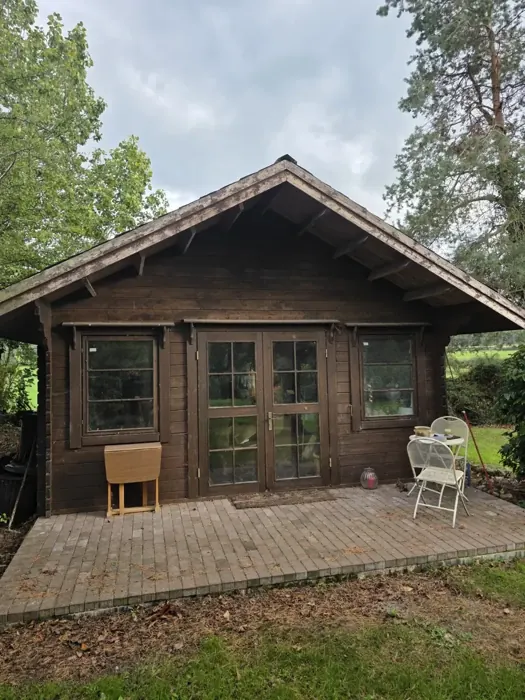 Front view of the timber cabin before work